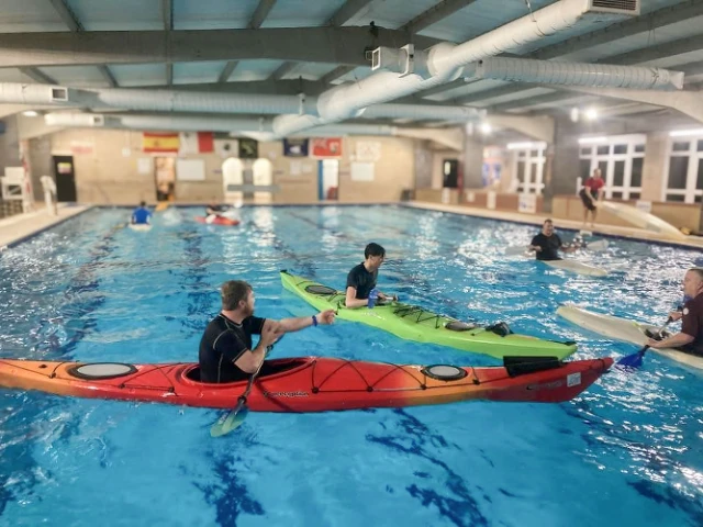 Several people practice kayaking
