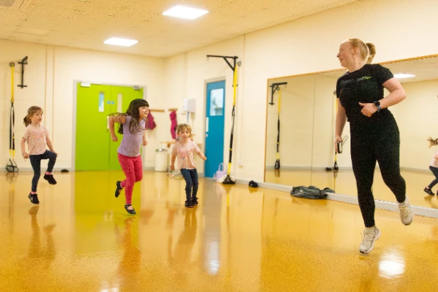 Children and an instructor take part in a kids dance class
