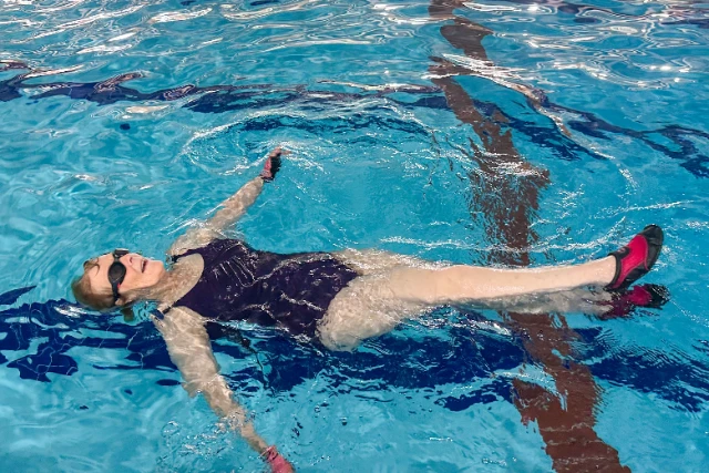 A woman floats on her back